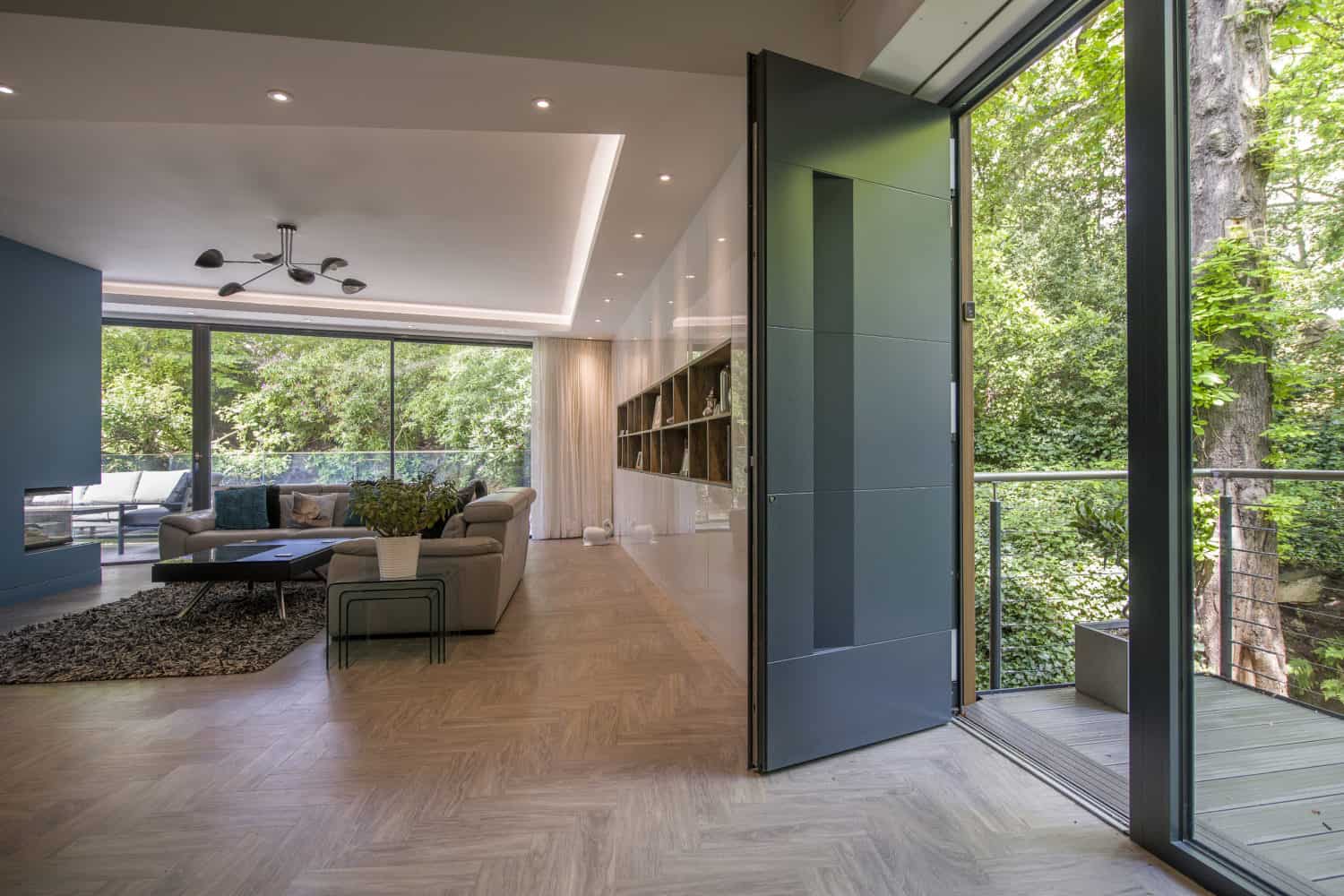 Opened luxury aluminium entrance door with 4 linear panels