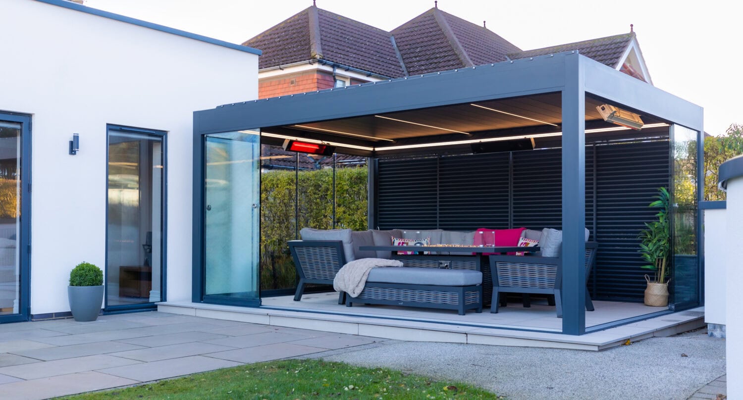 Aluminium pergola attached to the rear of a contemporary home, shown as a permanent extension of the living space